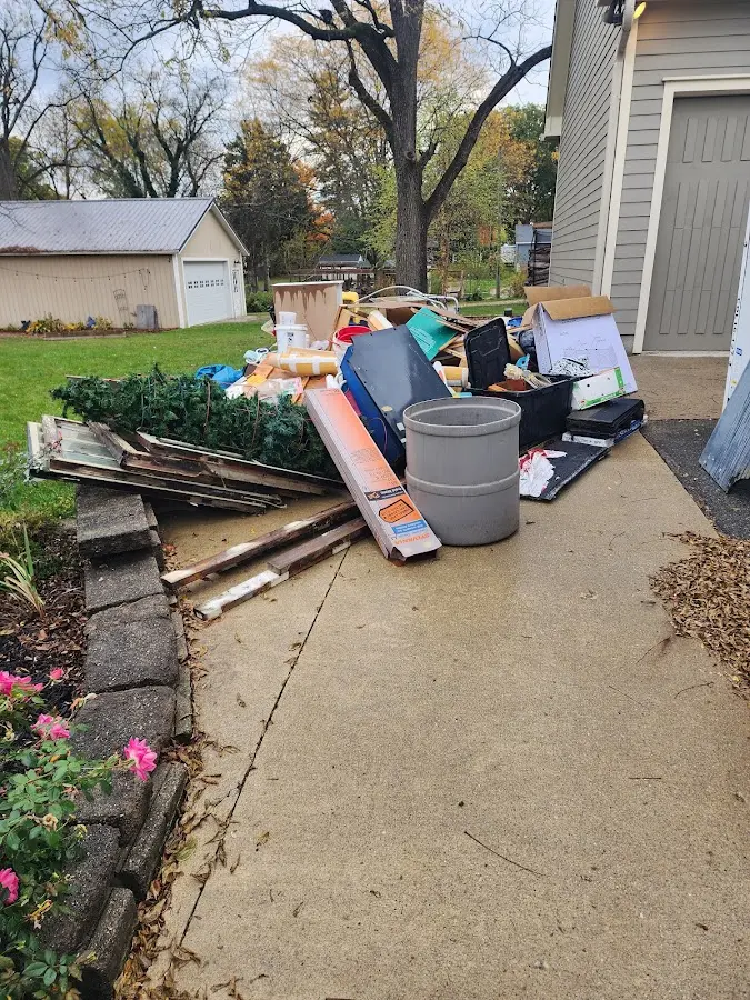 Dumpster being loaded with debris for 12 Yard Dumpster Rental in Alexandria